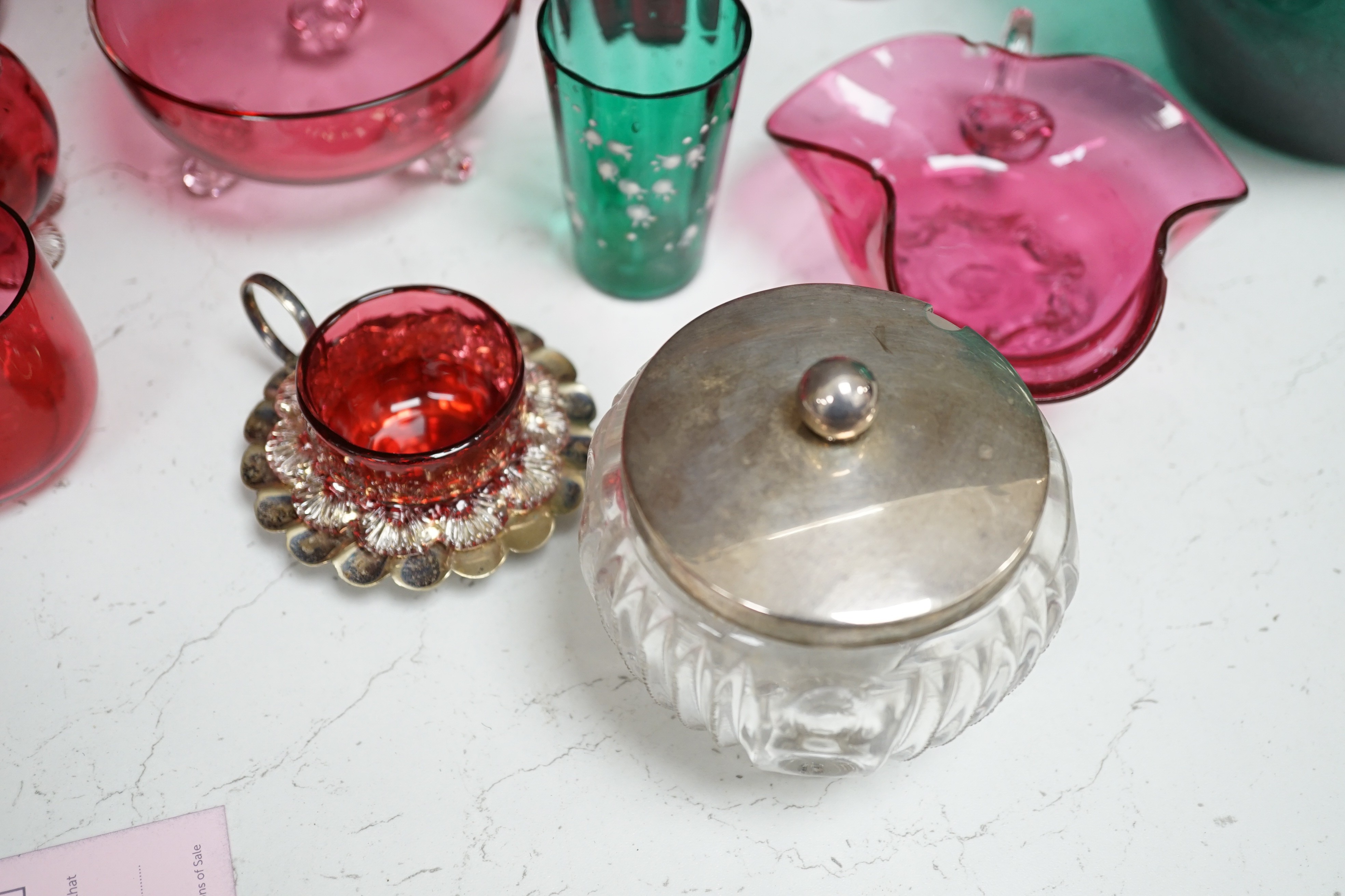 A collection of cranberry glass, a silver lidded glass sugar bowl, and enamelled glass historismus humpen etc